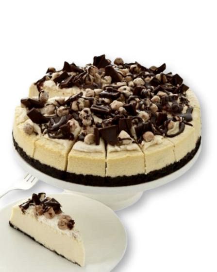 A cheesecake with chocolate chips and nuts on top.