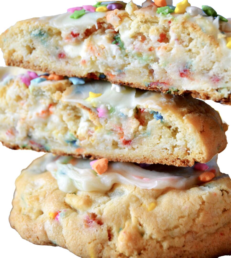 A stack of cookies with white frosting and colorful sprinkles.