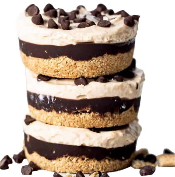 Three stacked cookies and cream cakes with chocolate chips.