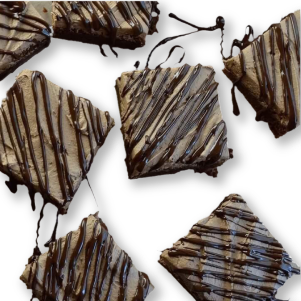 A close up of some chocolate squares with drizzled icing.