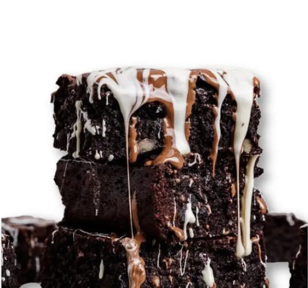 A stack of brownies with white frosting on top.