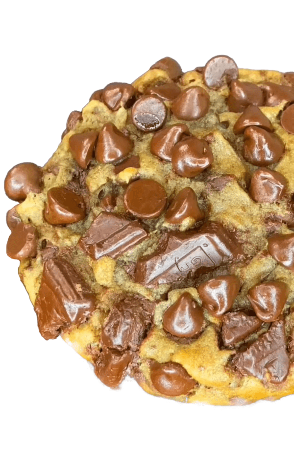 A chocolate chip cookie with candy on top of it.