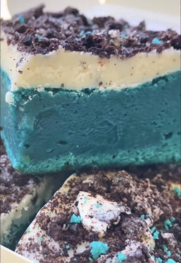 A close up of some cake with blue and white frosting