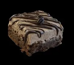 A brownie with chocolate frosting and a cookie on top.