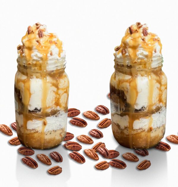 Two jars of ice cream with nuts on the side.
