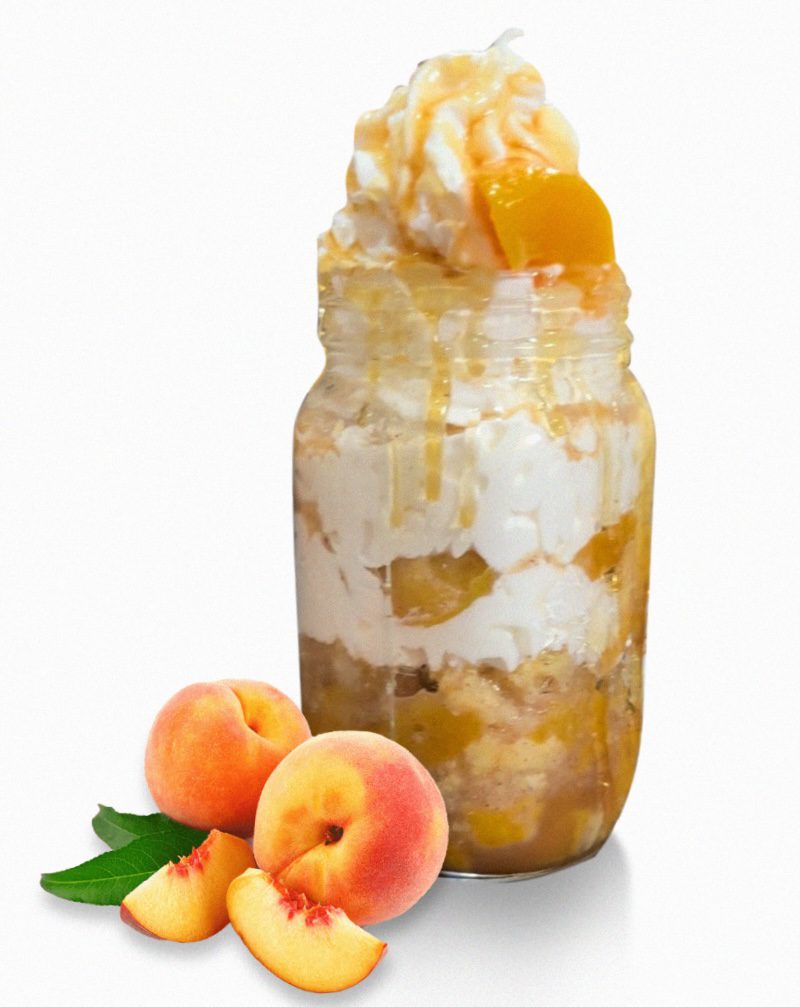 A jar of peaches and cream with some fruit on the side.