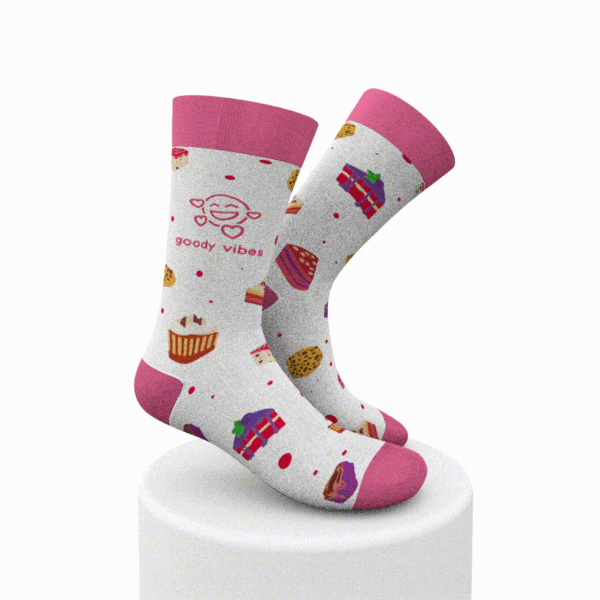 A pair of pink and white socks with cupcakes on them.