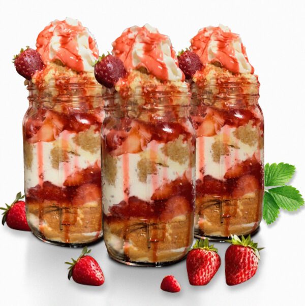 A group of jars filled with fruit and whipped cream.