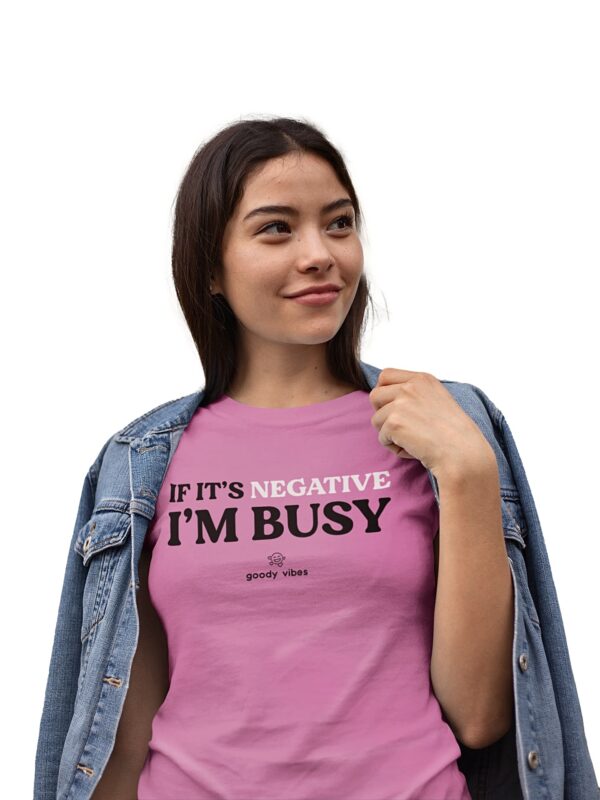 A woman is wearing a t-shirt that says " if it's negative i 'm busy ".