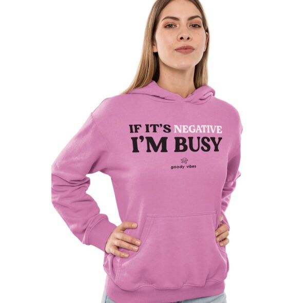 A woman wearing a pink hoodie with the words if it's negative, i 'm busy.
