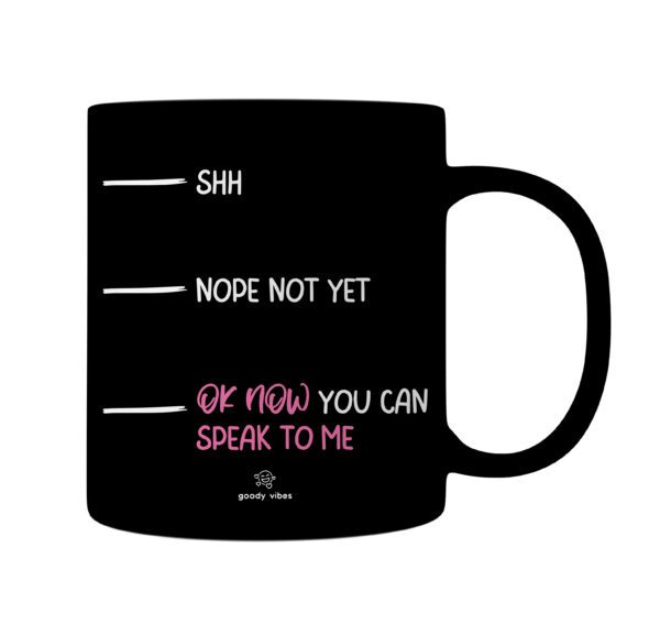 A black mug with the words shh nope not yet and of how you can speak to me written in pink.