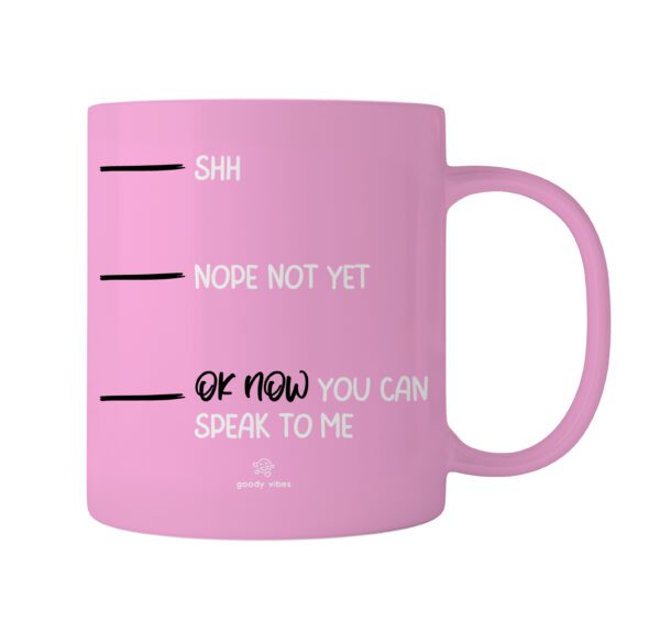 A pink coffee mug with the words " ok now you can speak to me ".